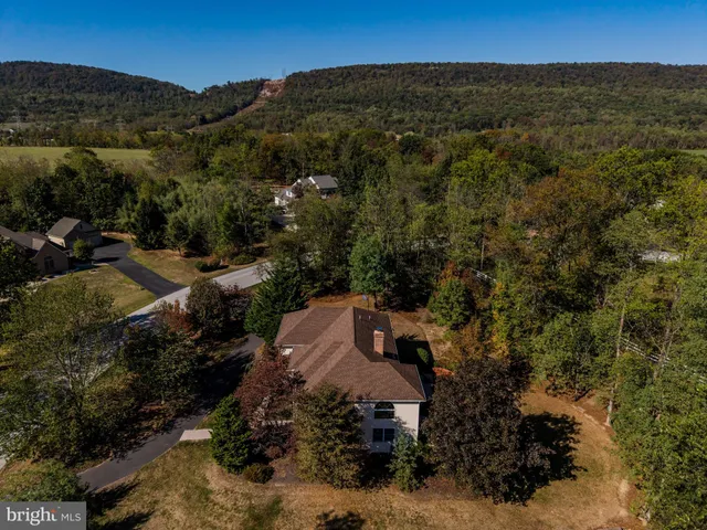 a view of a bench in the patio next to a yard