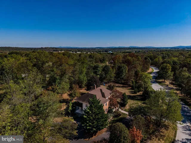 a backyard of a house with barbeque oven table and chairs