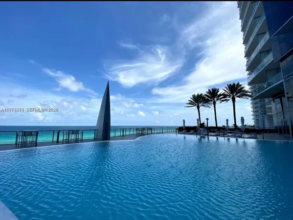 a view of a swimming pool with an outdoor seating