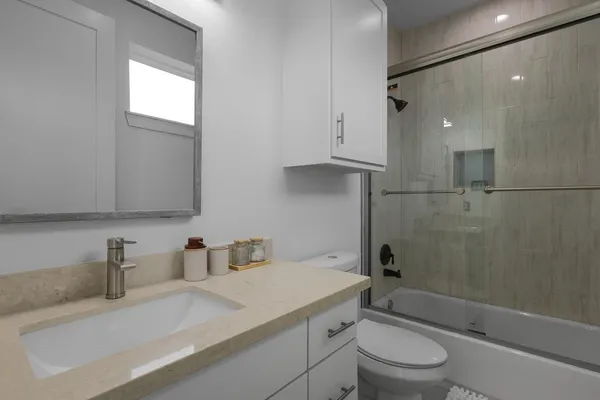 a spacious bedroom with a bed and a flat screen tv