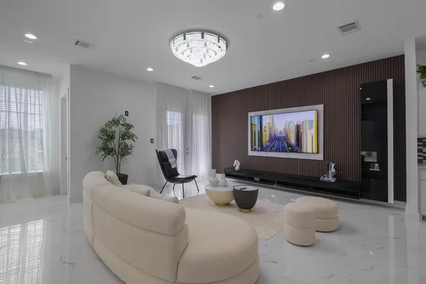 a living room with furniture and a chandelier