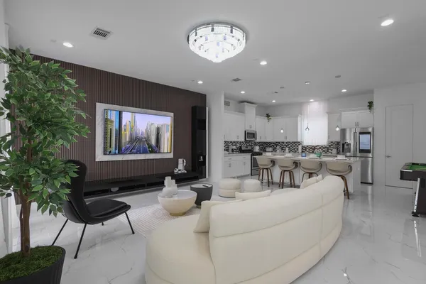 a living room with furniture and a chandelier