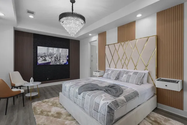 a bedroom with a bed and a flat screen tv