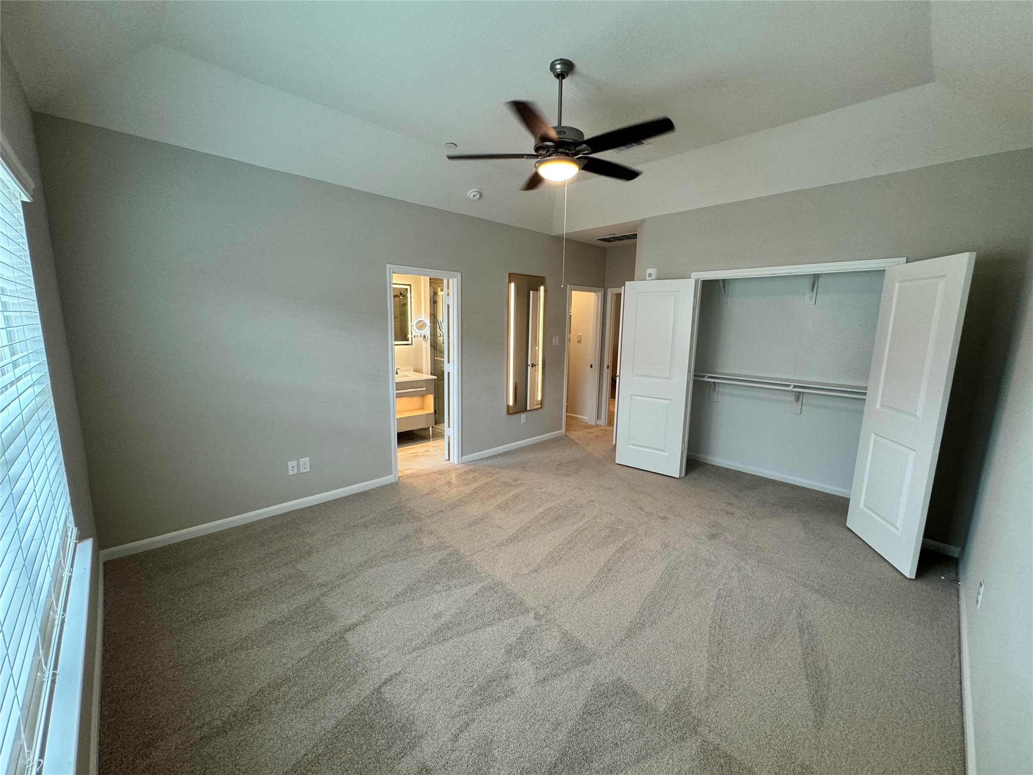 12400 Greens Road, Unit 1102 Atascocita, TX 77346 - Photo 11 of 23 an empty room with closet and windows