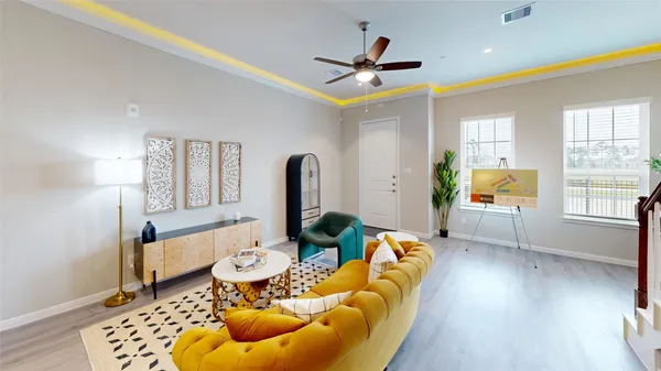 a living room with furniture fireplace and a window