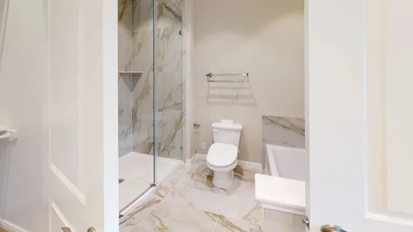a bathroom with a toilet and a shower