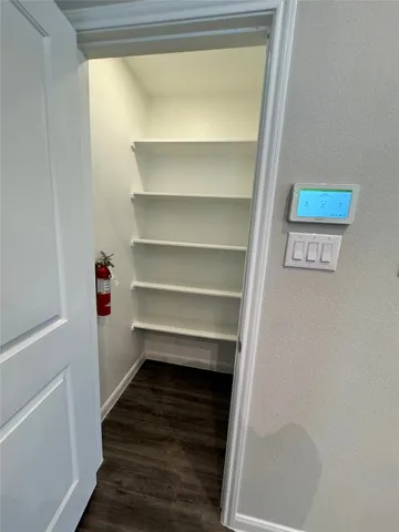 a view of walk in closet with empty racks