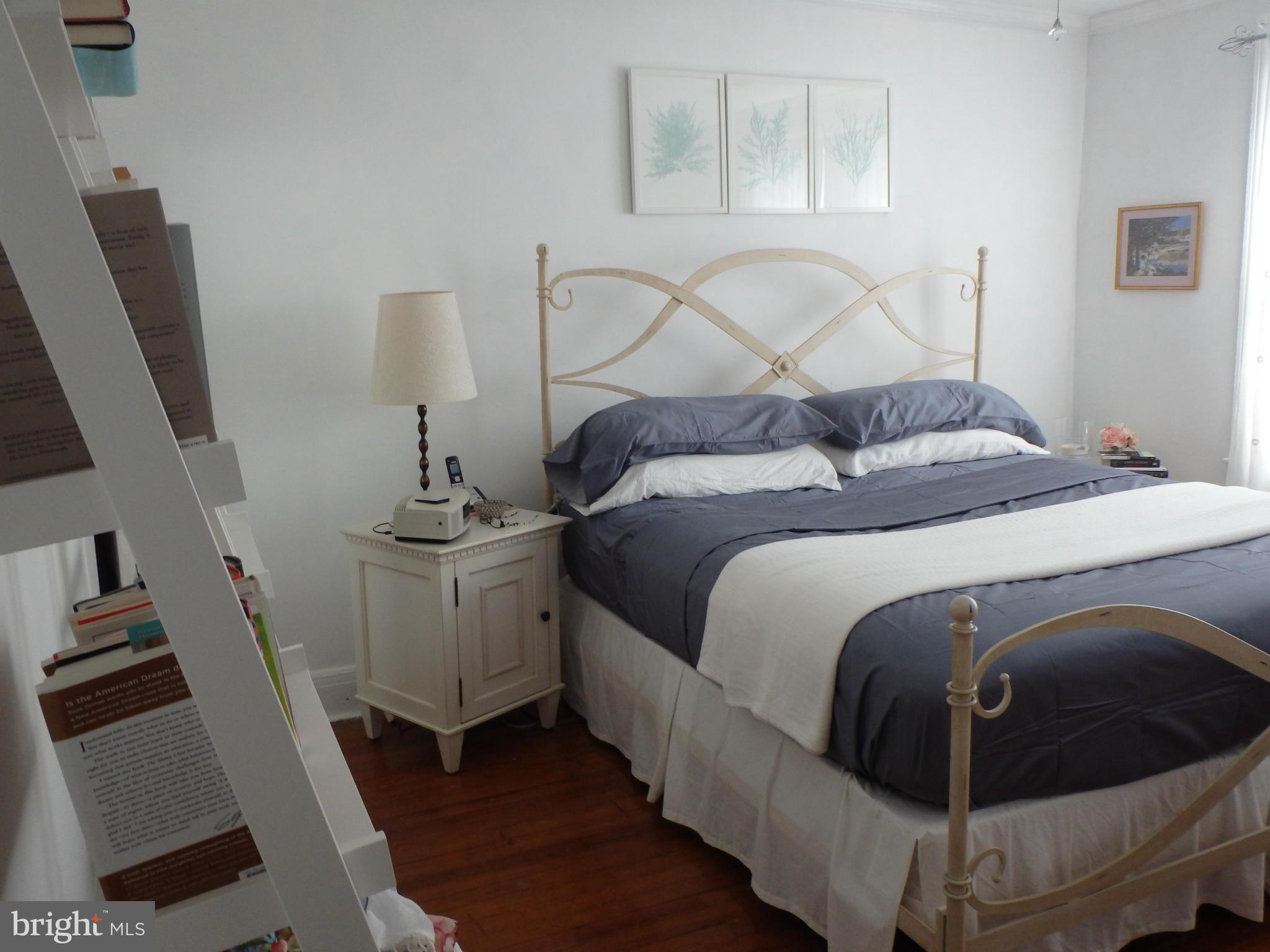 3630 Yolando Road Baltimore, MD 21218 - Photo 11 of 20 a bedroom with a bed and wooden floor
