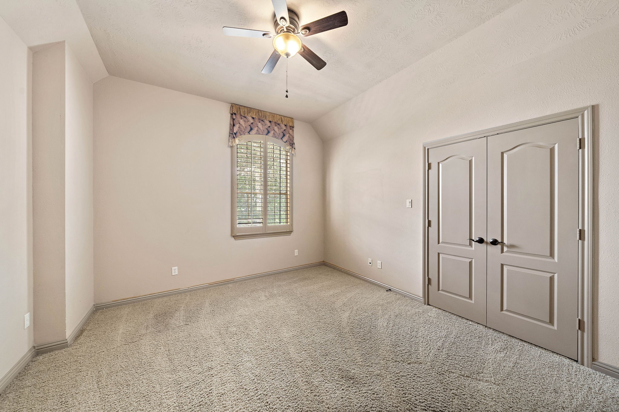 10015 Cinco Ridge Drive Katy, TX 77494 - Photo 13 of 17 a view of an empty room with a window