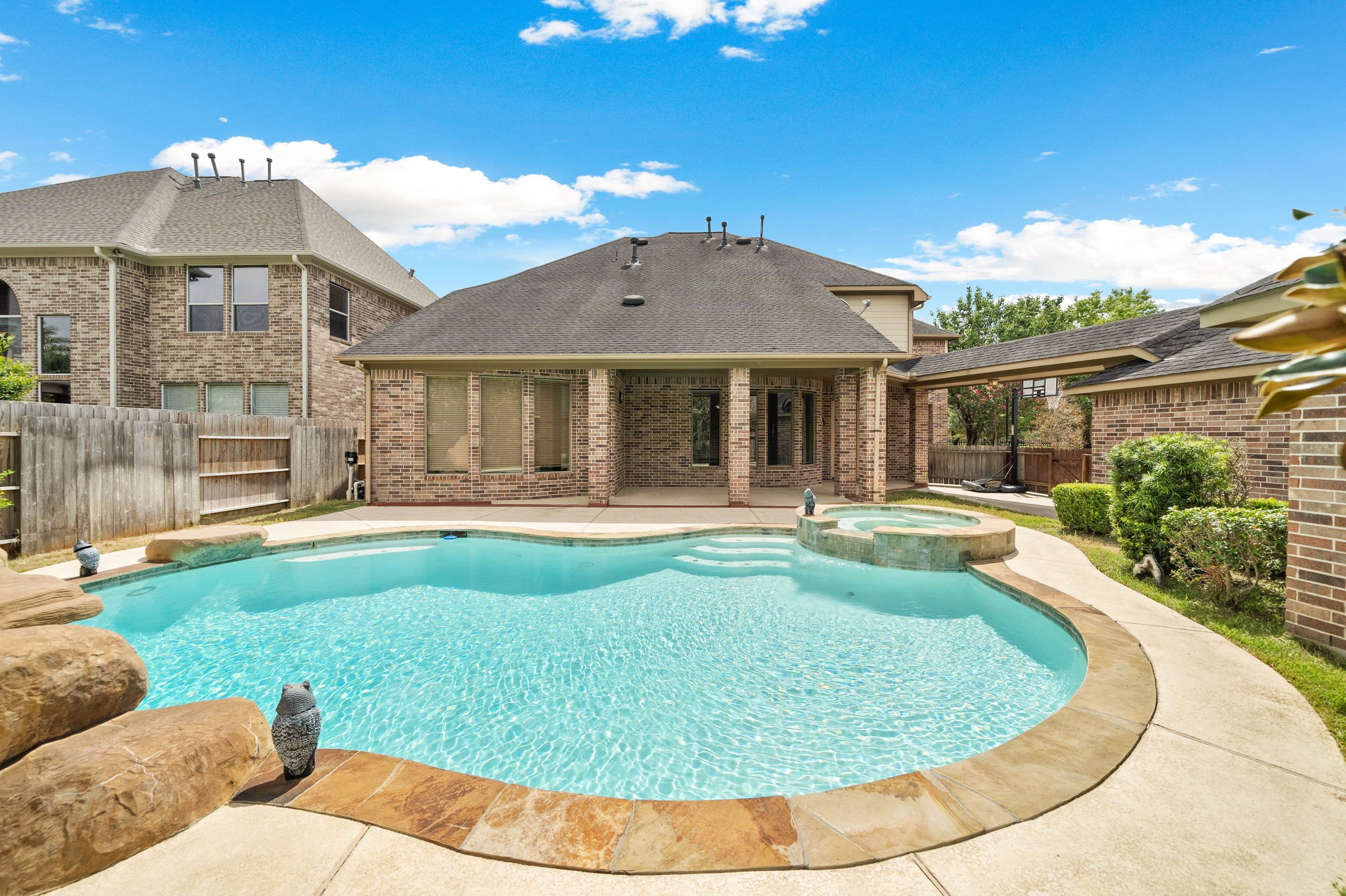 10015 Cinco Ridge Drive Katy, TX 77494 - Photo 17 of 17 a view of a house with swimming pool and porch