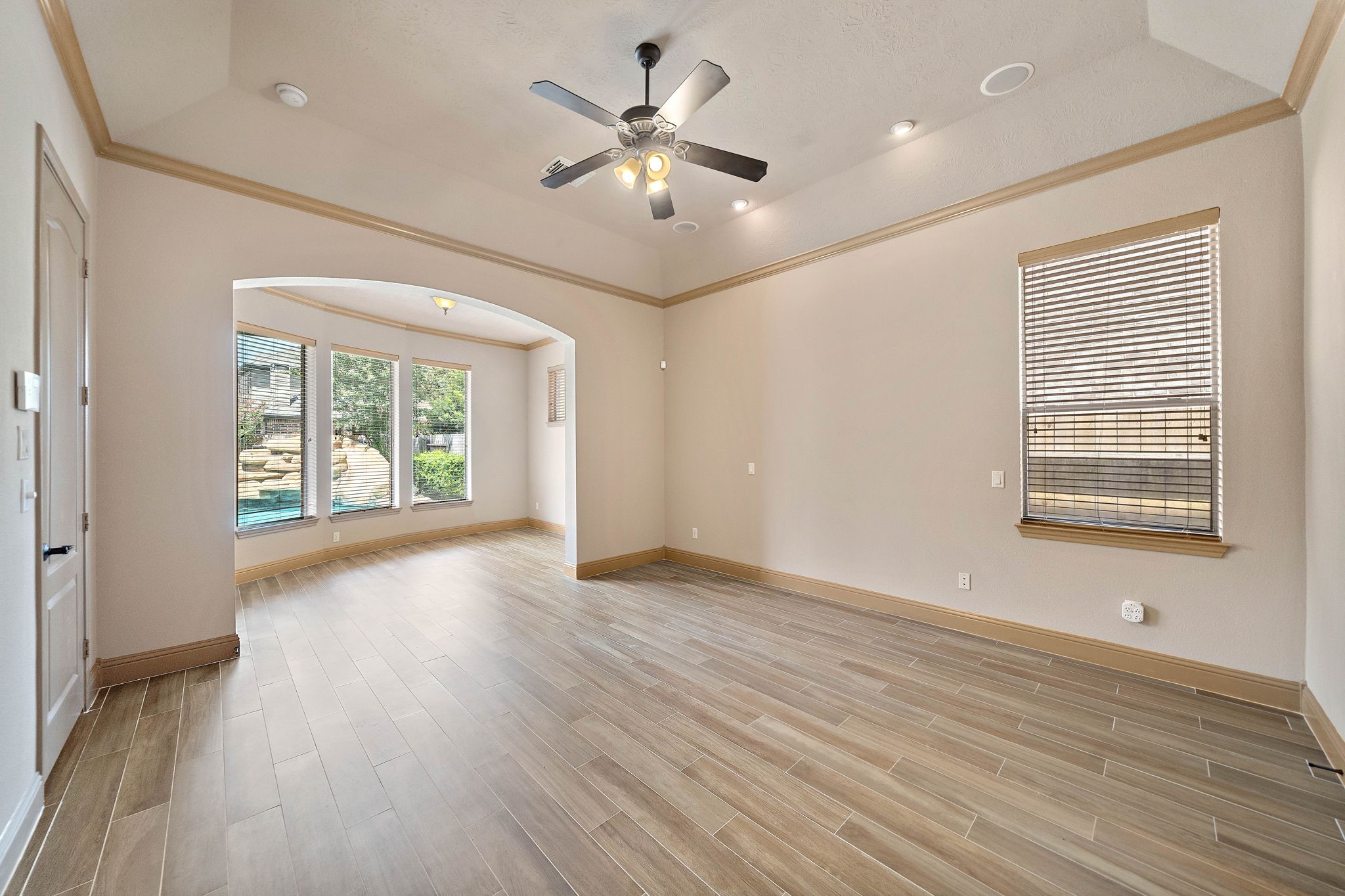 10015 Cinco Ridge Drive Katy, TX 77494 - Photo 7 of 17 a view of an empty room with a window and wooden floor