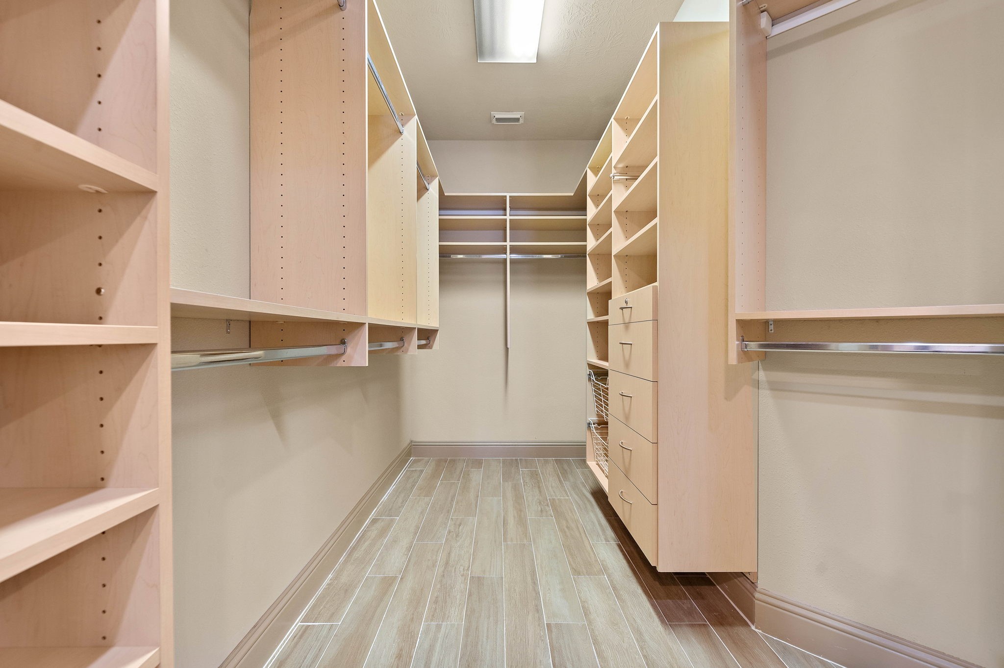 10015 Cinco Ridge Drive Katy, TX 77494 - Photo 9 of 17 a view of walk in closet with empty racks