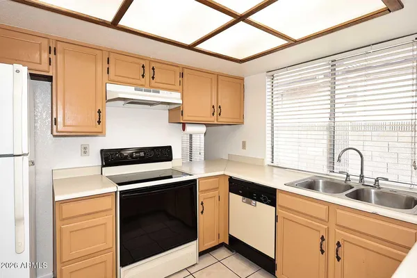 a kitchen with a sink window and cabinets