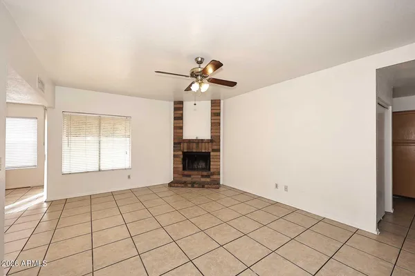 a view of an empty room with a fireplace