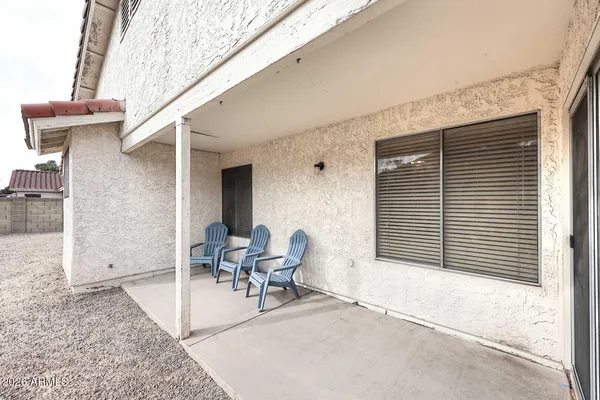 a balcony with table and chairs