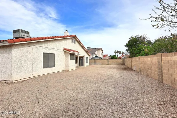 a view of a house with wooden fence