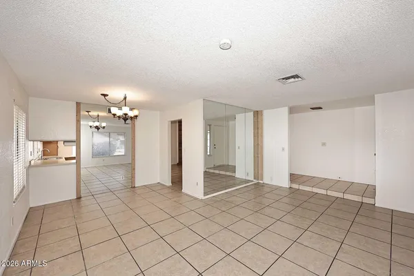 a view of a room with an entryway and chandelier