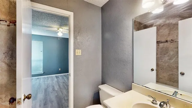 a bathroom with a toilet tub and shower