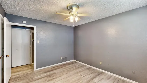 a view of a room with a ceiling fan