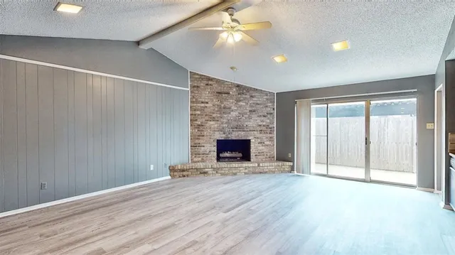 wooden floor fireplace and natural light in room