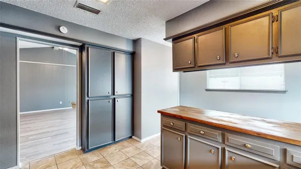 a kitchen with stainless steel appliances granite countertop a refrigerator and microwave