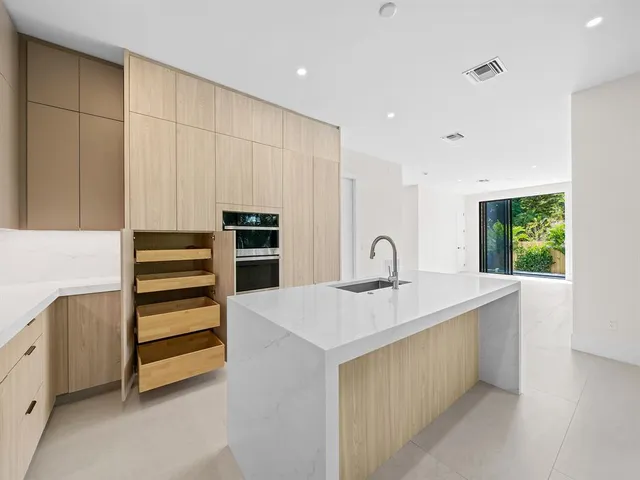 a kitchen with a sink and a stove top oven