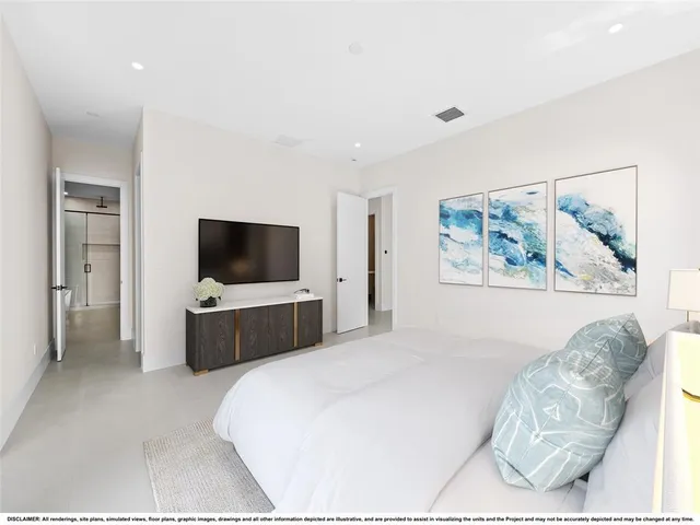 a bedroom with a bed and a television