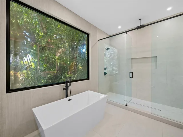 a bathroom with a bathtub and a large window