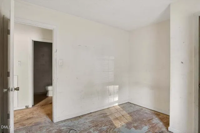 an empty room with a windows