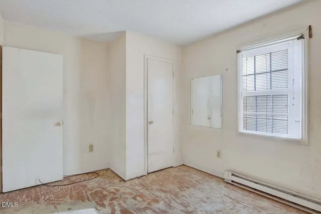 wooden view of a bathroom with a glass door shower and a sink
