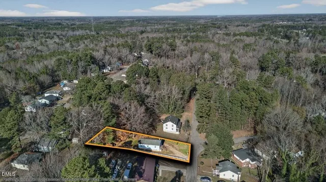 a view of a wooden sign in a field