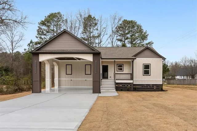 a view of a house with a yard covered in snow