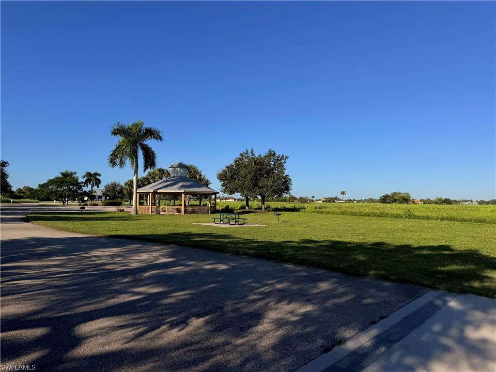 2012 Silk Bay Boulevard Alva, FL 33920 - Photo 7 of 9 a view of a lake with a house in the background
