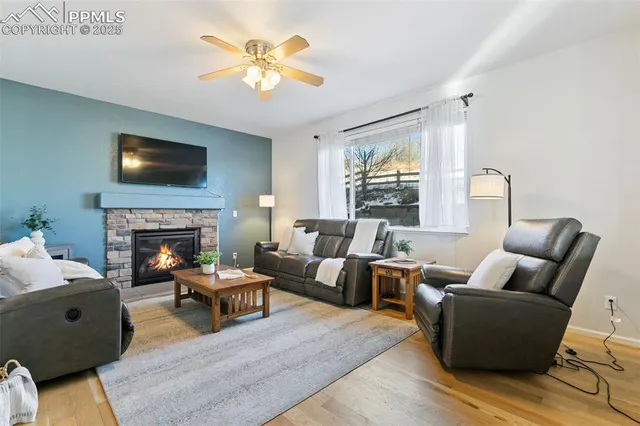 a living room with furniture a fireplace and a flat screen tv