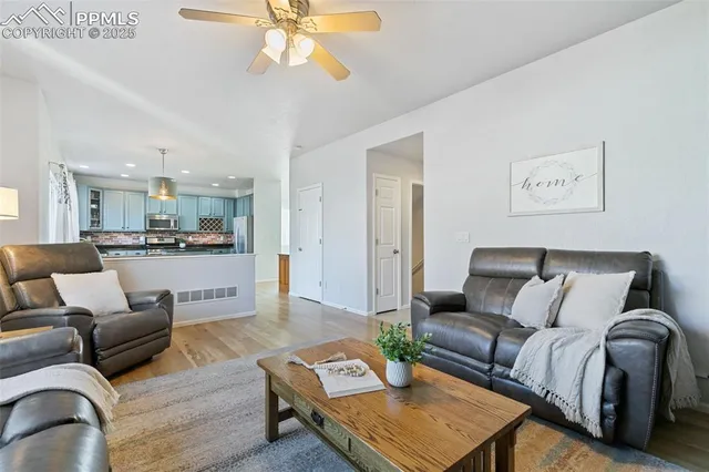 a living room with furniture and kitchen view