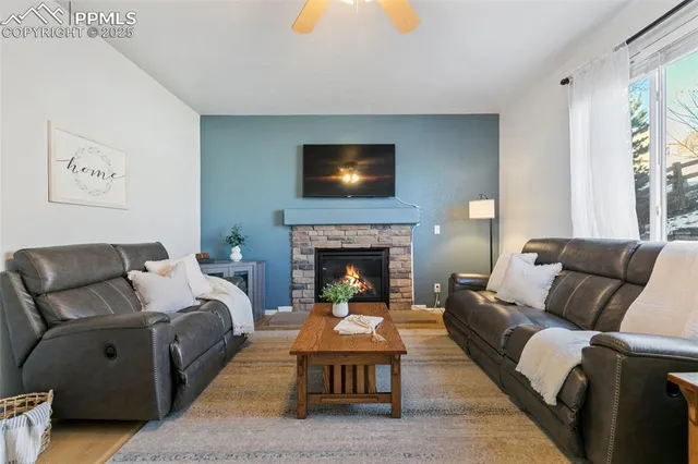 a living room with furniture and a fireplace