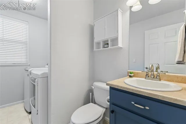a bathroom with a sink vanity mirror and toilet