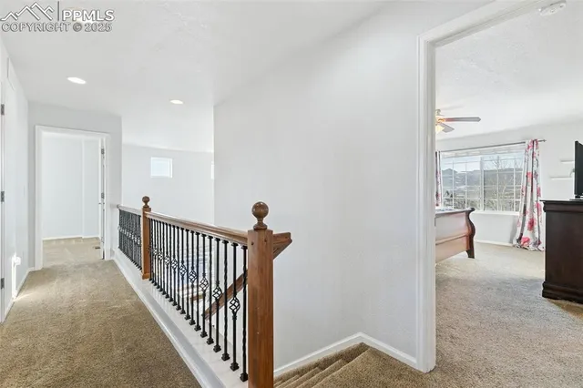 a view of a hallway with a livingroom and entryway