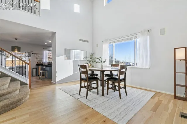a dining room with furniture and wooden floor