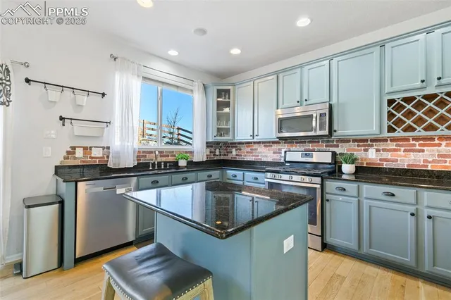 a kitchen with granite countertop a sink and cabinets