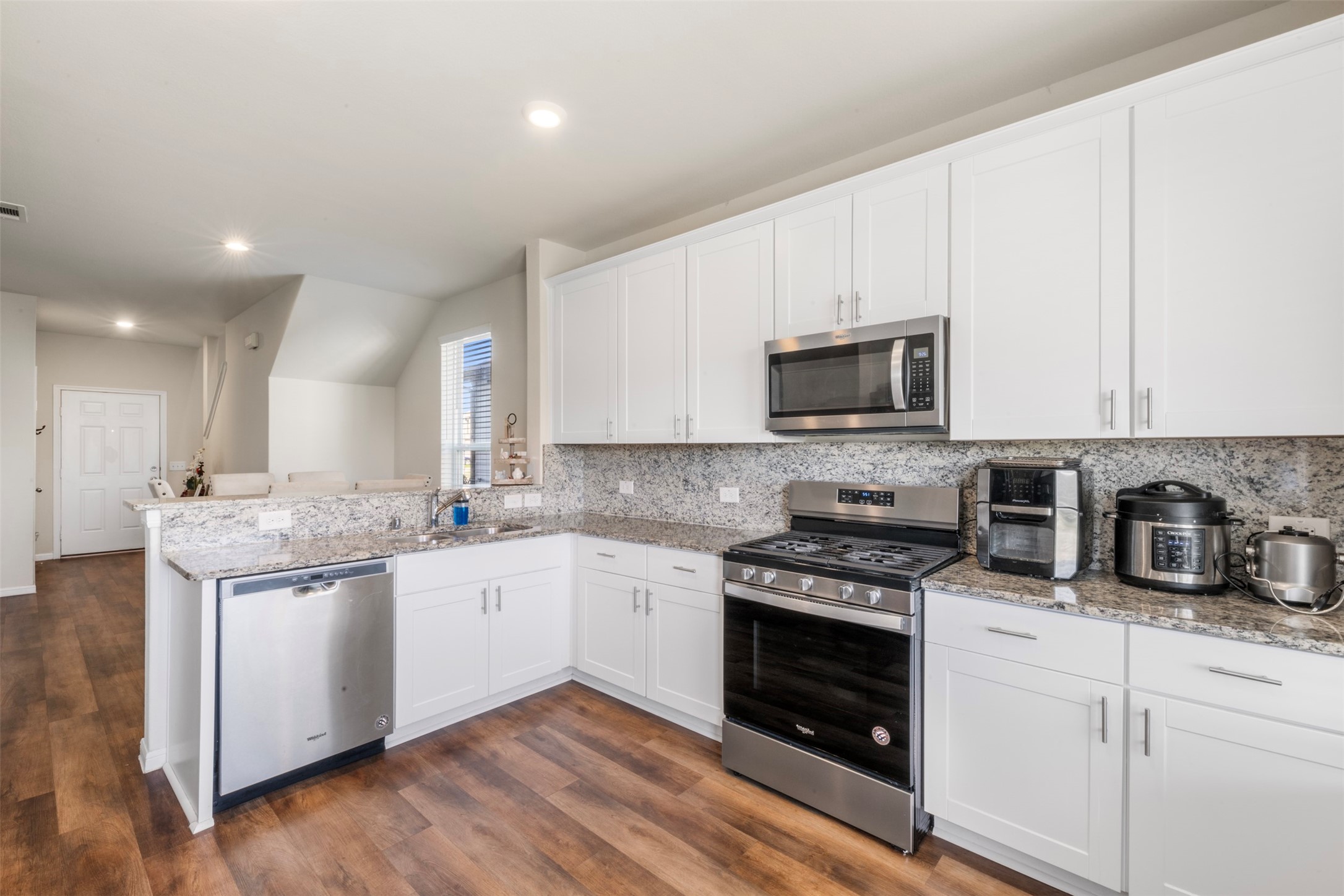4611 Prairie Chase Drive Houston, TX 77069 - Photo 12 of 44 a kitchen with granite countertop white cabinets and white appliances
