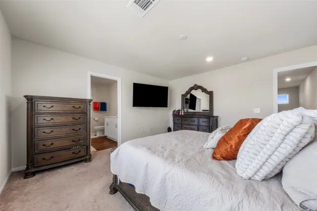 a bedroom with a bed and a television