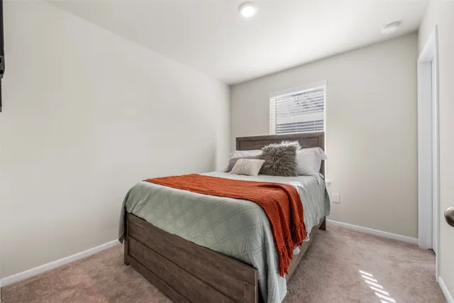 a bedroom with a bed and window