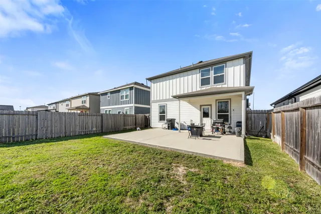 a view of a house with backyard porch and sitting area