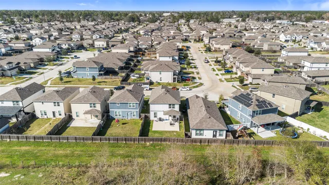 an aerial view of residential houses with outdoor space