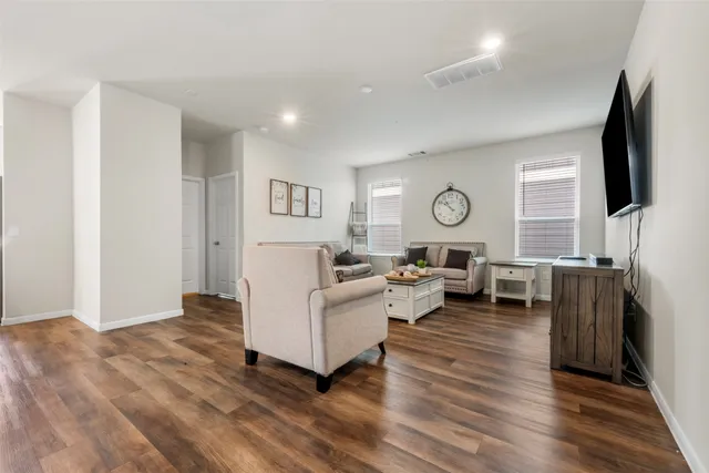 a living room with fireplace furniture and a flat screen tv