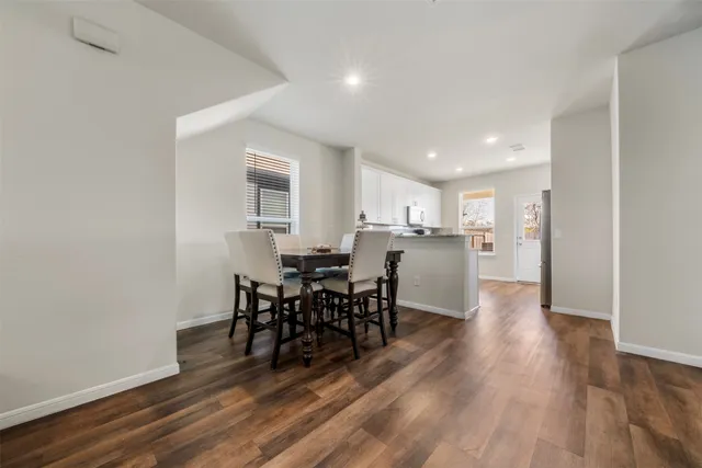 a view of a dining room with furniture and wooden floor