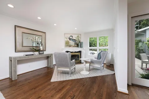 a living room with fireplace furniture and a wooden floor