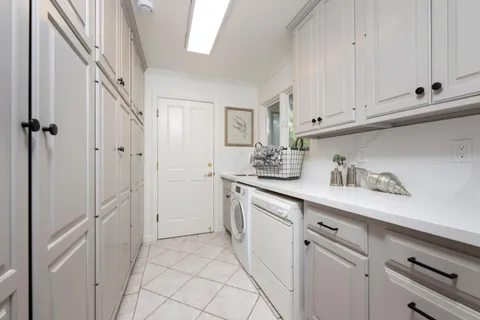 a kitchen with white cabinets and white appliances