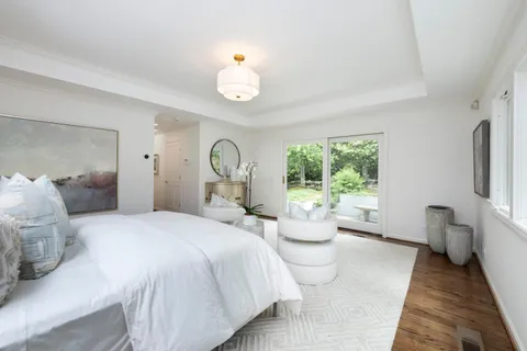 a bedroom with a large bed and a large window